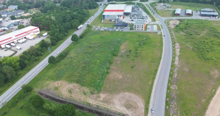 Rendsburg-Port-Sued_Parzelle GE 1-0 Gewerbefläche im Rendsburg Port Süd. Im Hintergrund eine Gewerbeimmobilie.